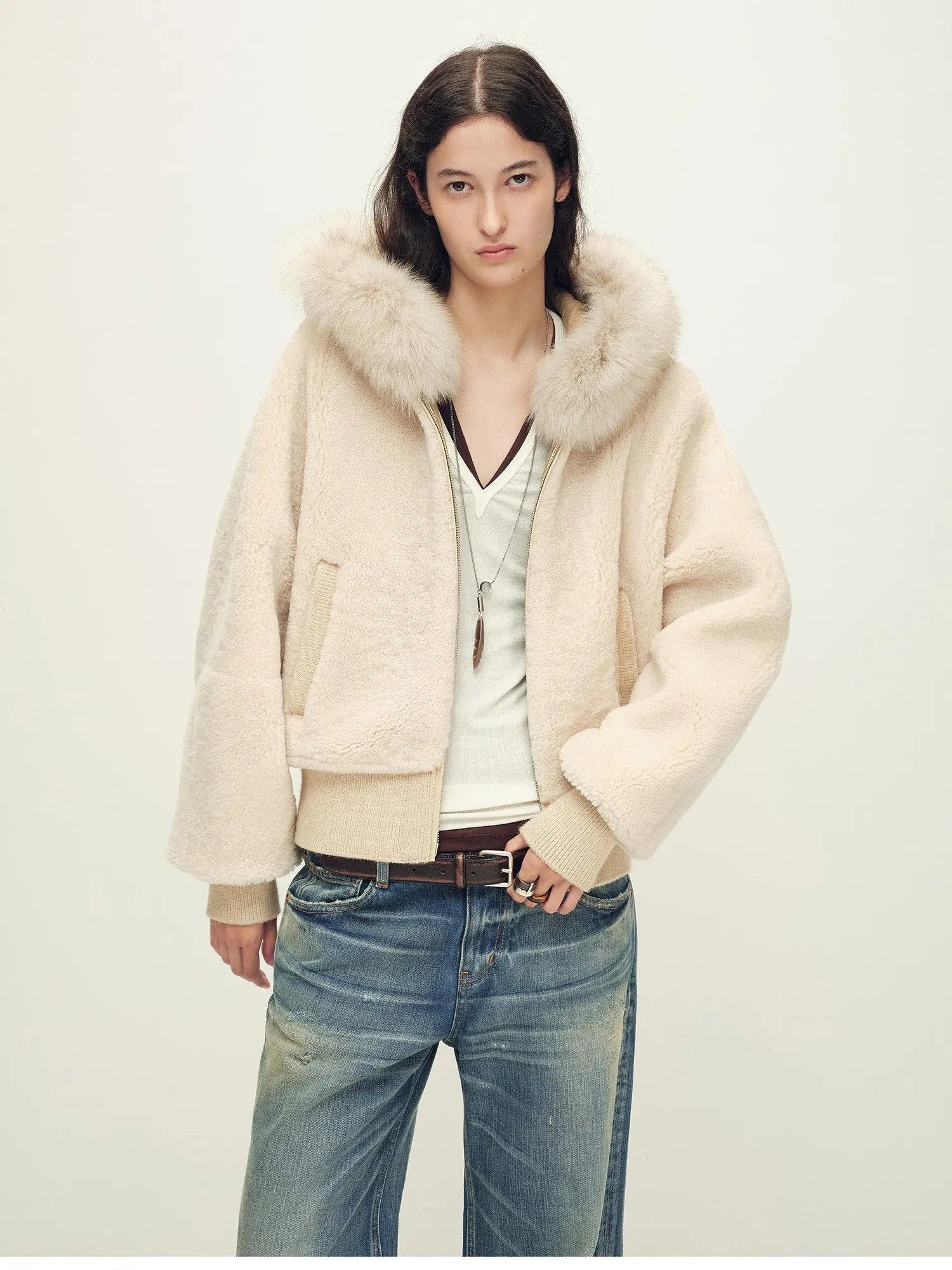 Model wearing Hokkaido Melody off-white short hooded Merino shearling jacket, close view