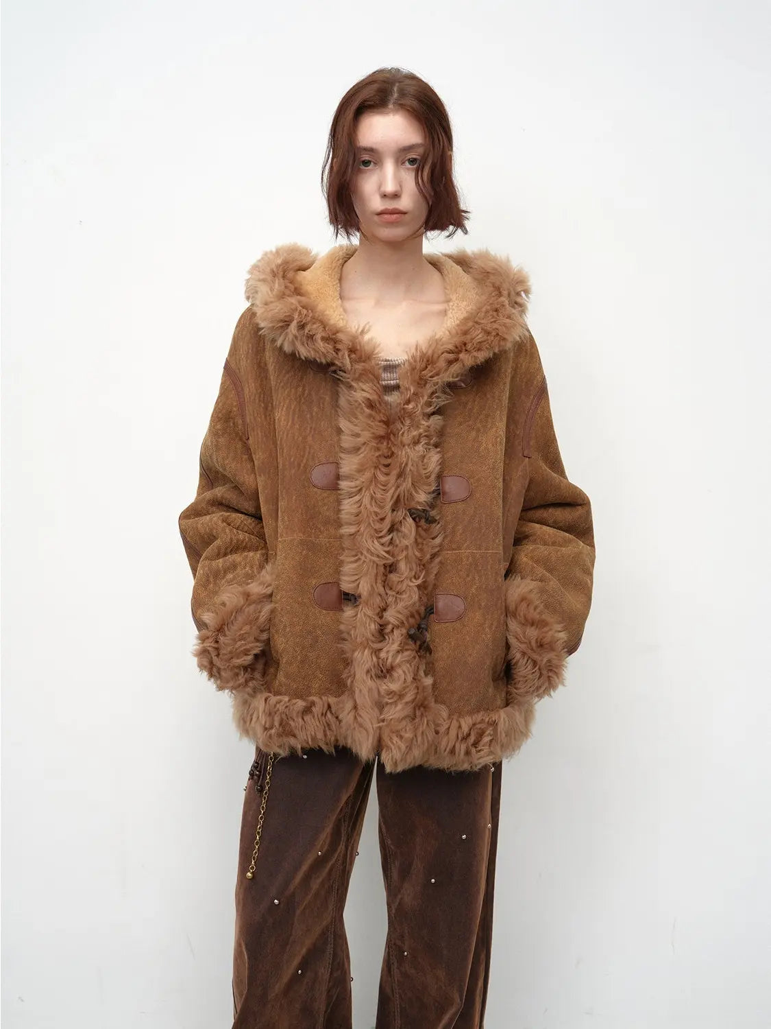 Model wearing the camel hooded Merino shearling jacket, view 1