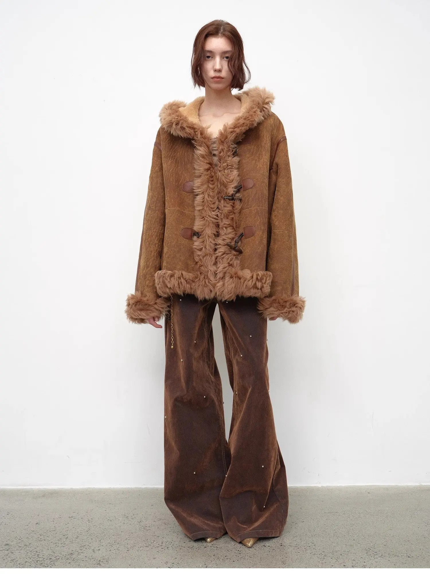 Model wearing the camel hooded Merino shearling jacket, view 4