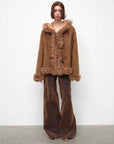 Model wearing the camel hooded Merino shearling jacket, view 4