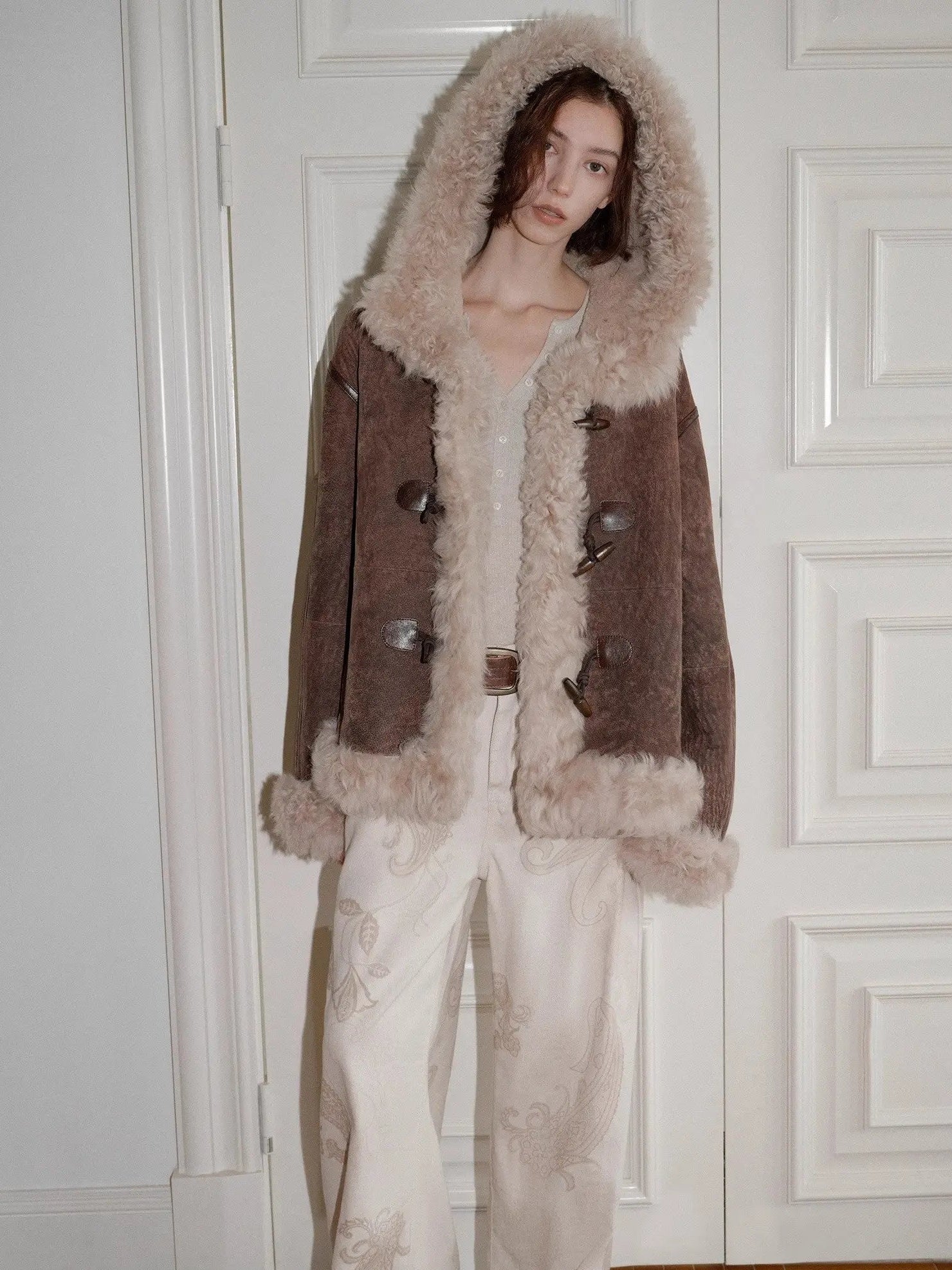 Model wearing the fog brown hooded Merino shearling jacket, view 2