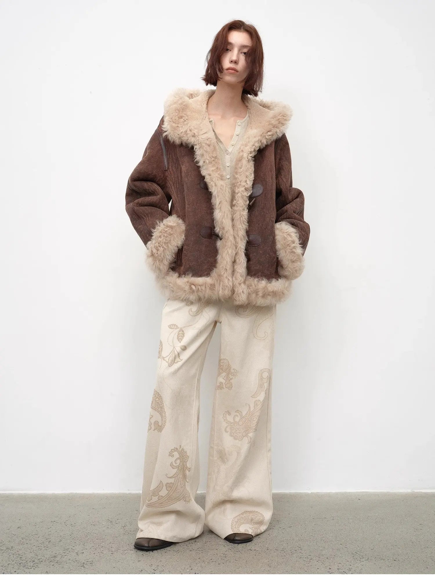 Model wearing the fog brown hooded Merino shearling jacket, view 4