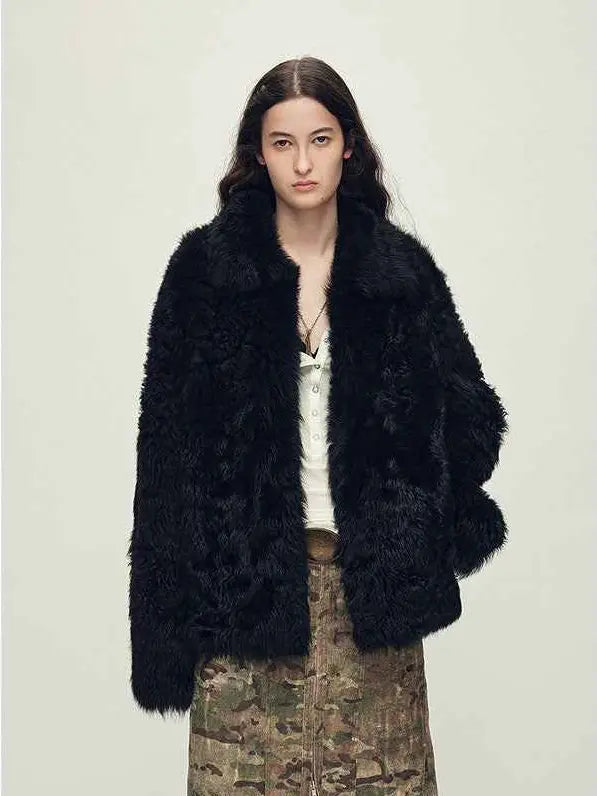 Woman wearing the Icelandic Bell Sound black Toscana curly coat, front view