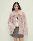 Woman wearing the Icelandic Bell Sound dirty pink Toscana coat, front view