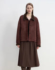 Model wearing the Knight's Contract reddish brown Merino shearling coat