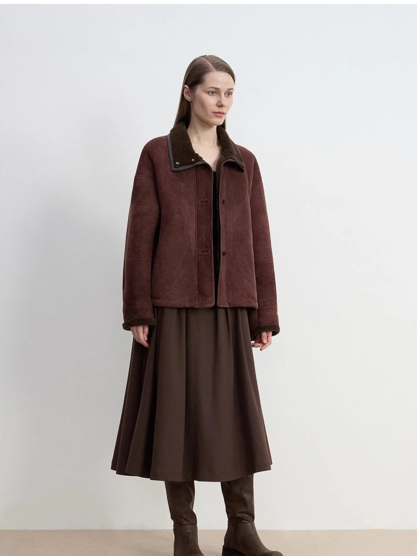 Reddish brown Merino shearling coat with high fur collar on model