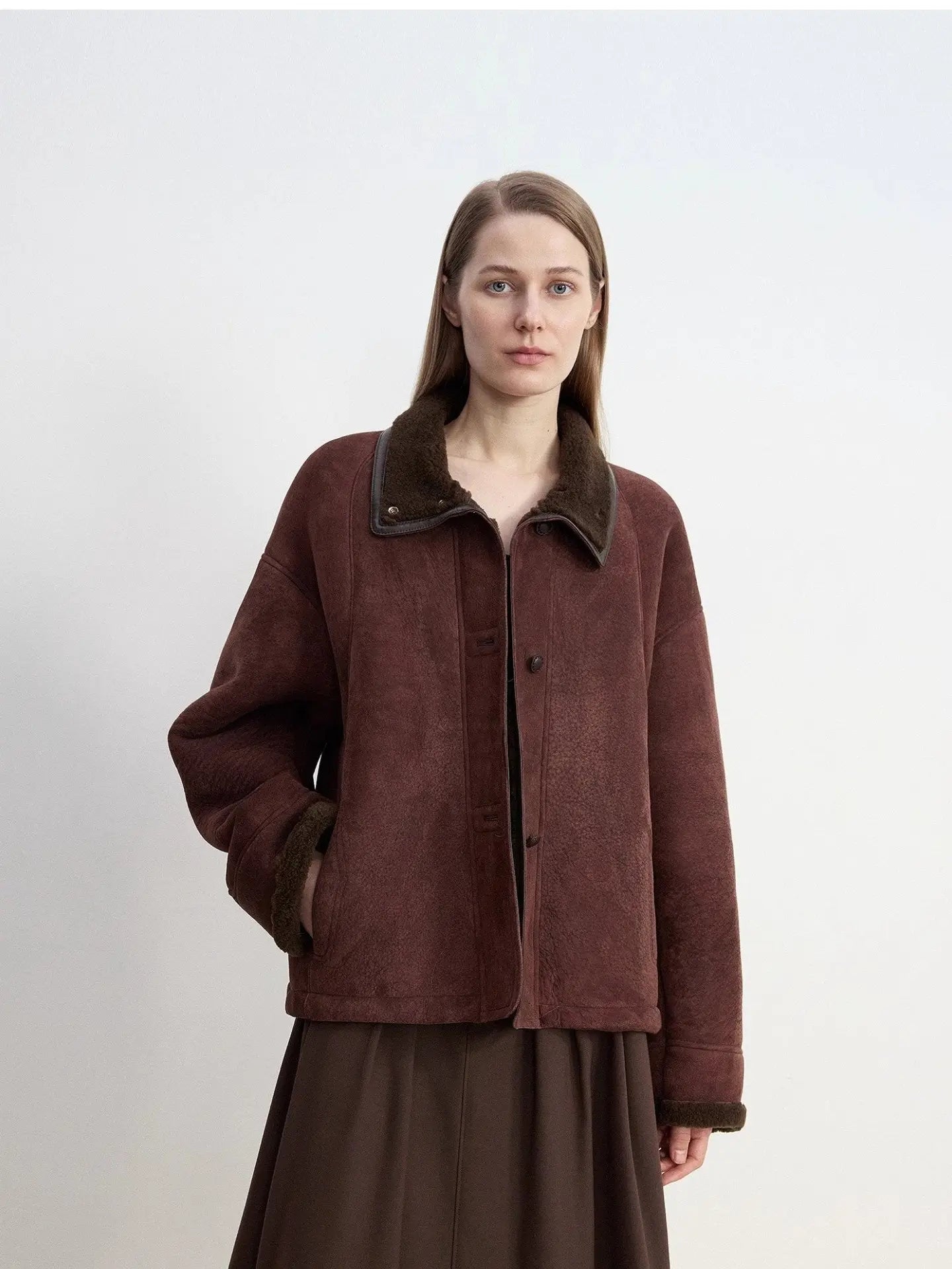 Reddish brown shearling coat showing structured winter silhouette