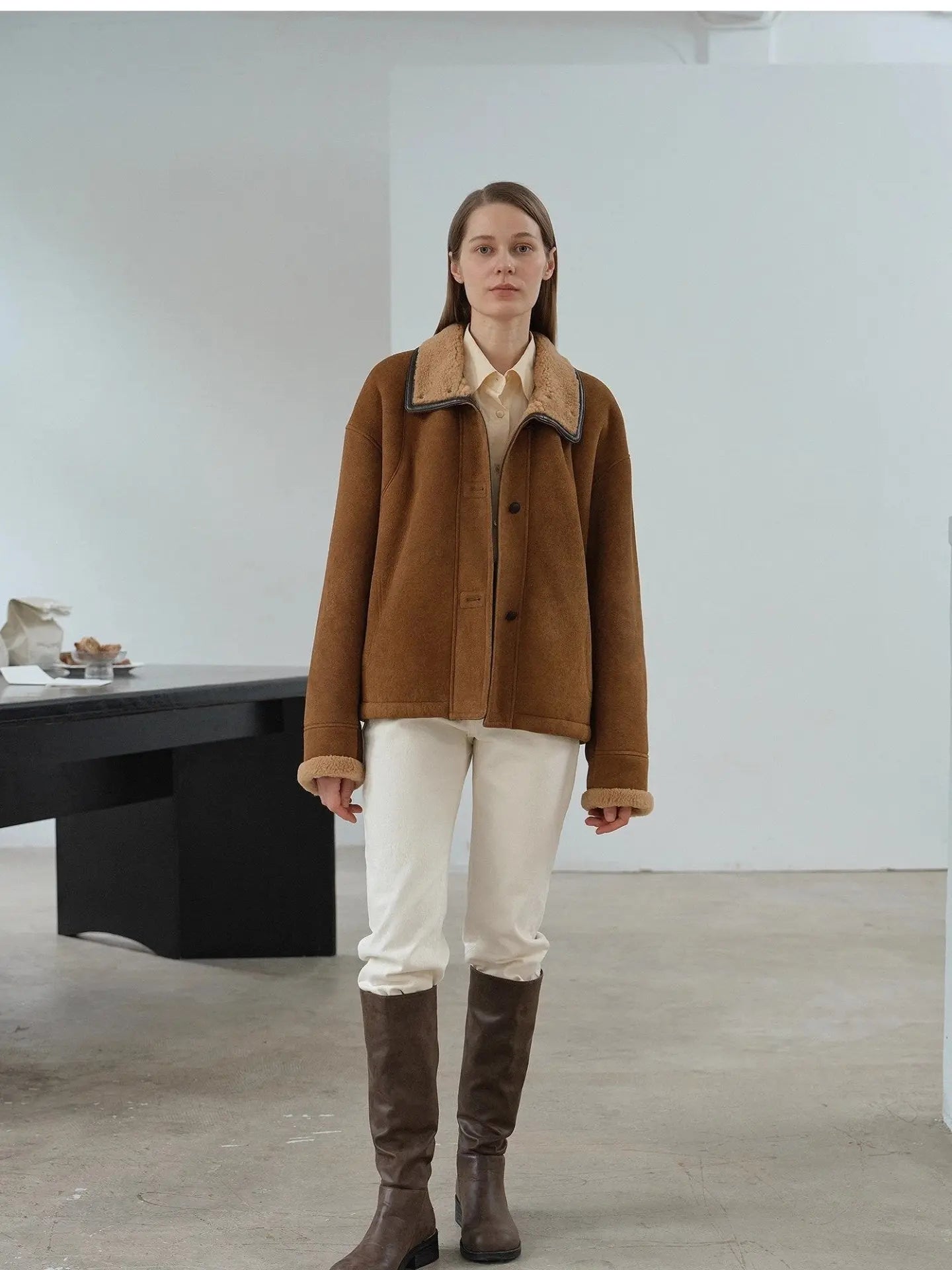 Yellowish brown Merino shearling coat with high fur collar on model