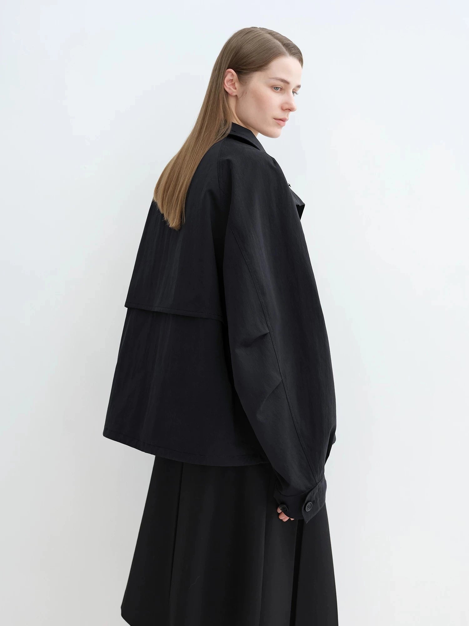 Side view of black Letrans Silent Trace parka with relaxed raglan sleeve