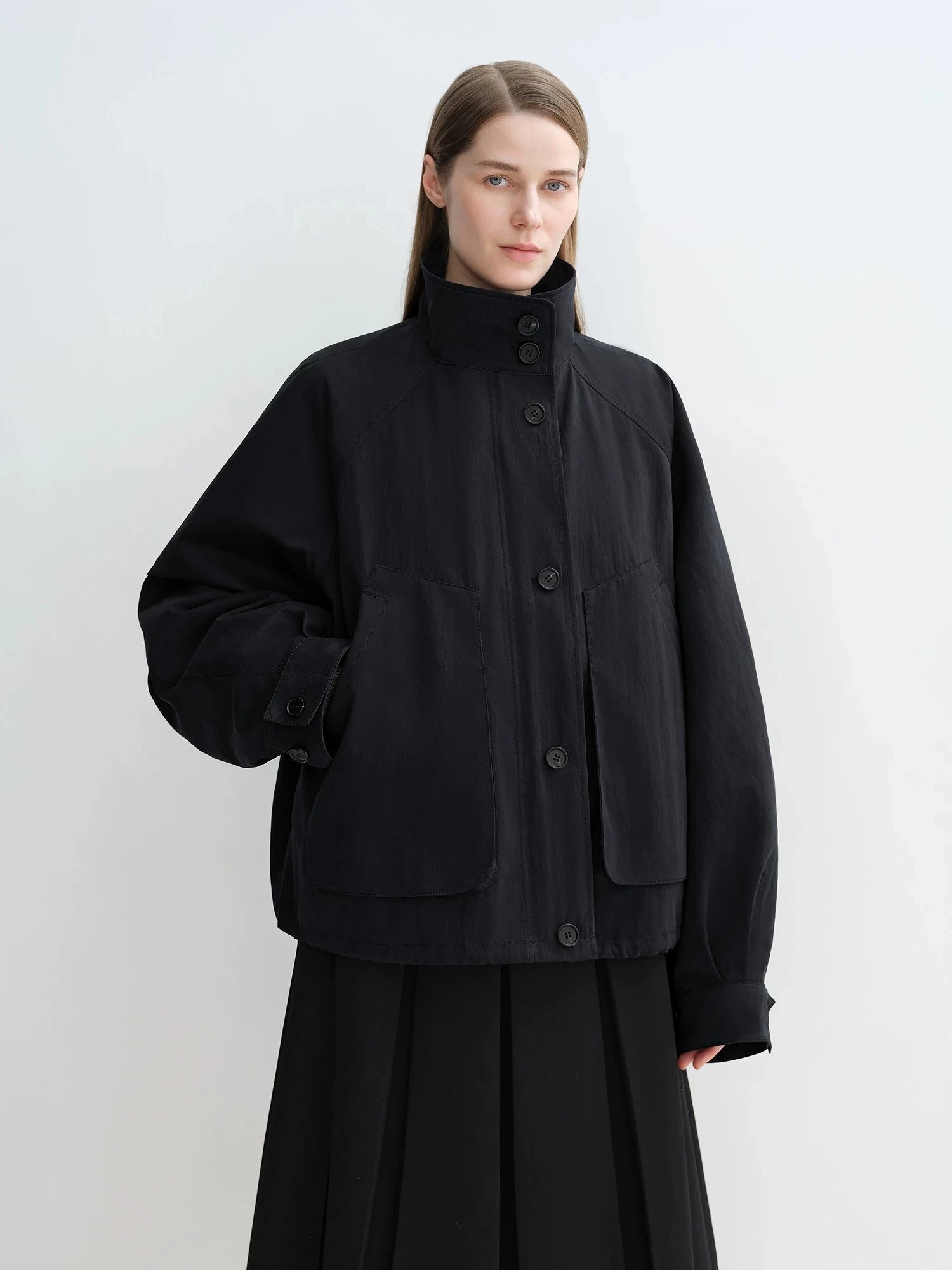 Black Letrans Silent Trace parka worn with stand collar and no fur collar