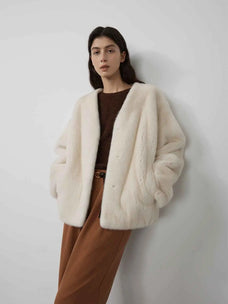 Model wearing Fireladyfur Louvre Pearl Natural mink V-neck jacket front view