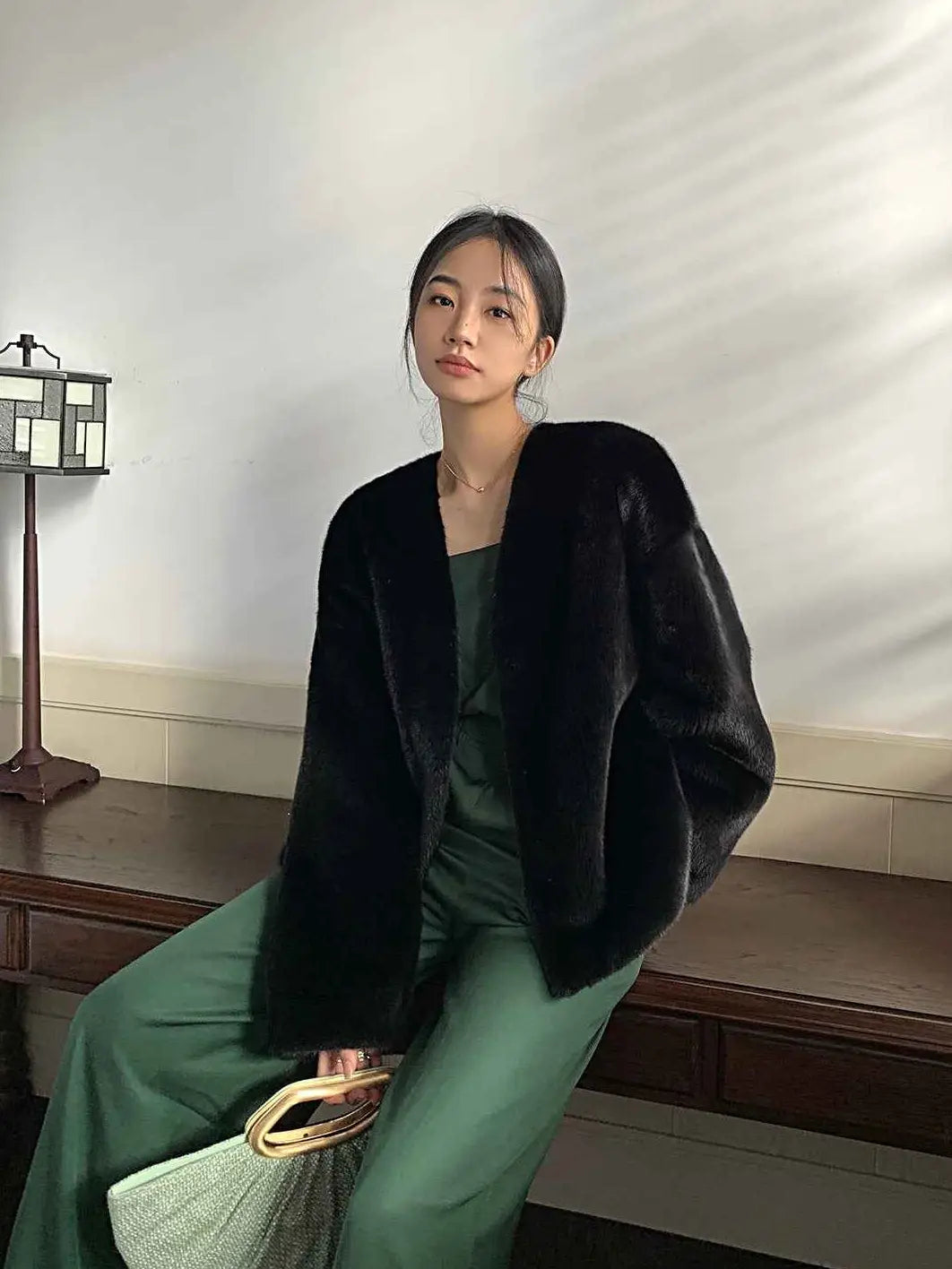 Model wearing Fireladyfur Louvre Blackglama Legend Black mink V-neck jacket seated view