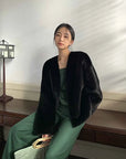 Model wearing Fireladyfur Louvre Blackglama Legend Black mink V-neck jacket seated view