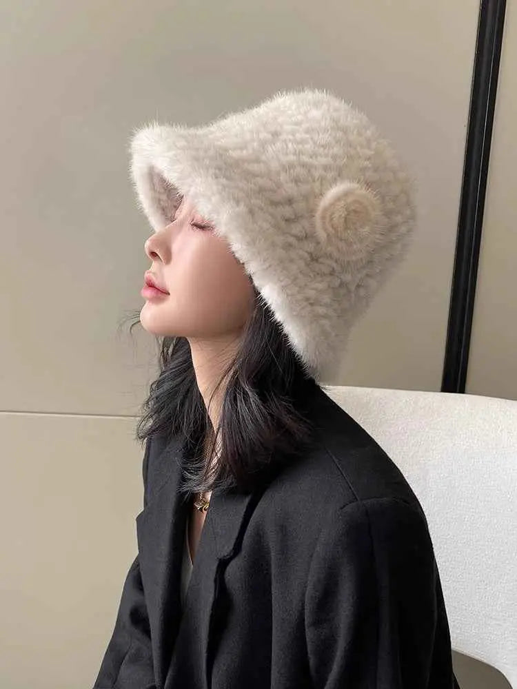 Woman wearing a white mink woven bucket hat in side profile
