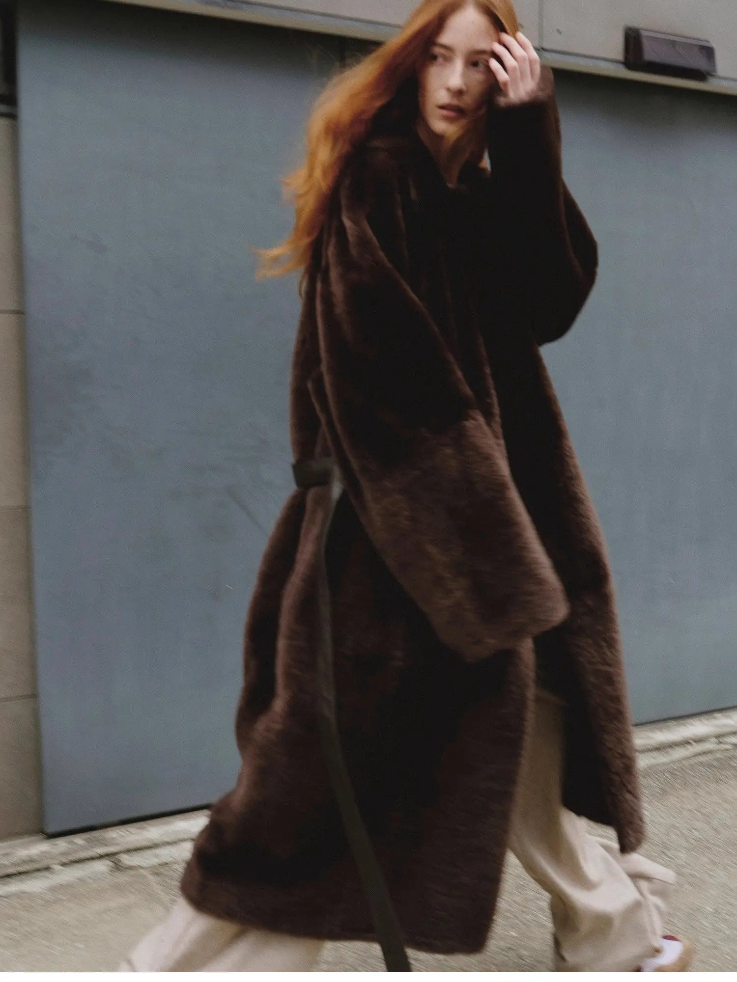 Copper brown Merino shearling coat with asymmetric placket on model