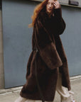 Copper brown Merino shearling coat with asymmetric placket on model