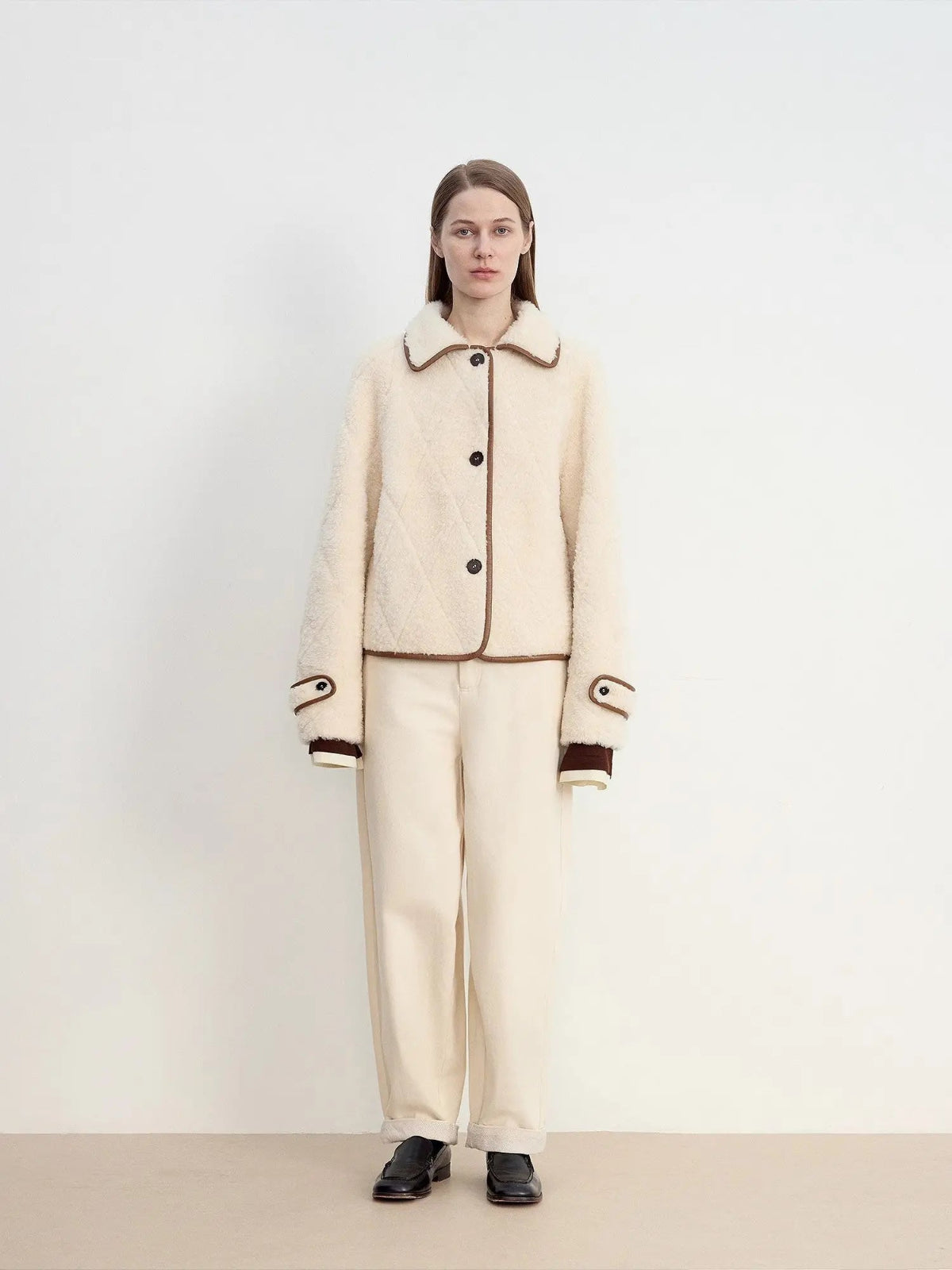 Woman wearing the off-white contrast-trim shearling jacket, full front view