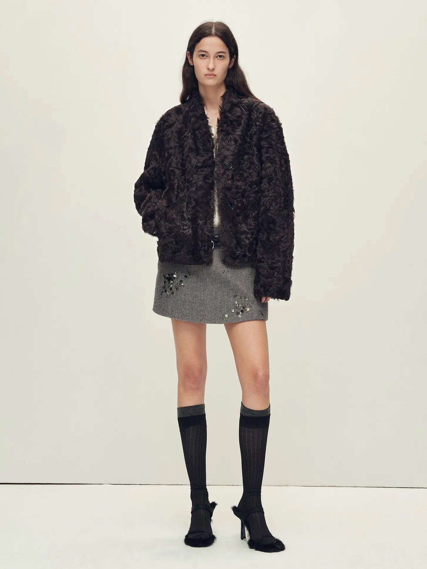 Model wearing the Mole Manor purple plum lake lamb shearling coat, full-length view