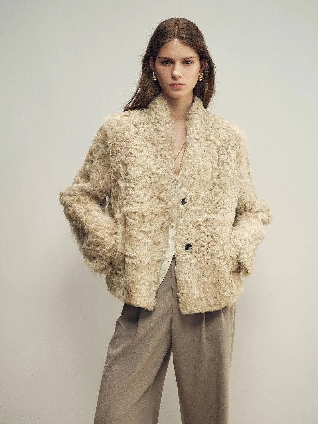 Model wearing the Mole Manor taro pink lake lamb shearling coat, close front view