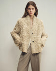 Model wearing the Mole Manor taro pink lake lamb shearling coat, close front view
