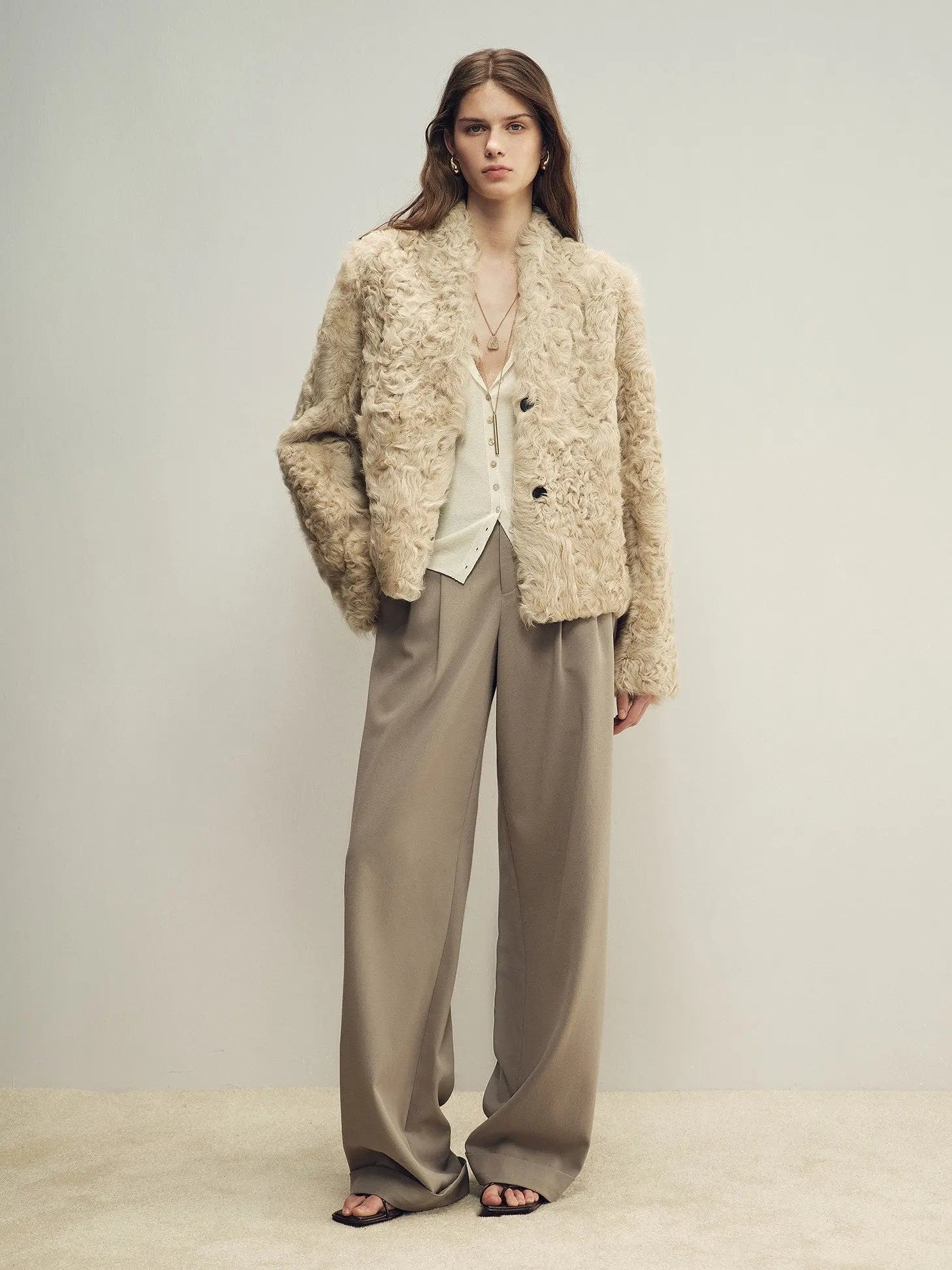 Model wearing the Mole Manor taro pink lake lamb shearling coat, full-length view