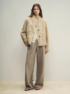 Model wearing the Mole Manor taro pink lake lamb shearling coat, full-length view