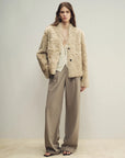 Model wearing the Mole Manor taro pink lake lamb shearling coat, full-length view