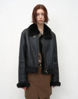 Woman wearing the black Toscana wool shearling motorcycle jacket, front view
