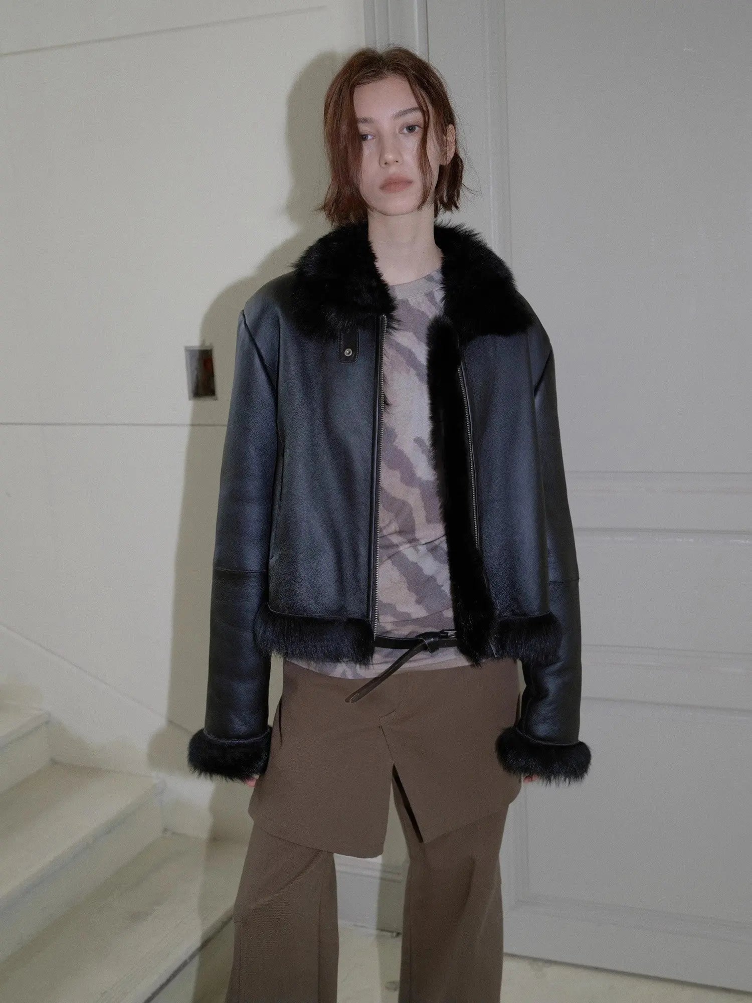 Woman modeling the black Toscana shearling motorcycle jacket indoors