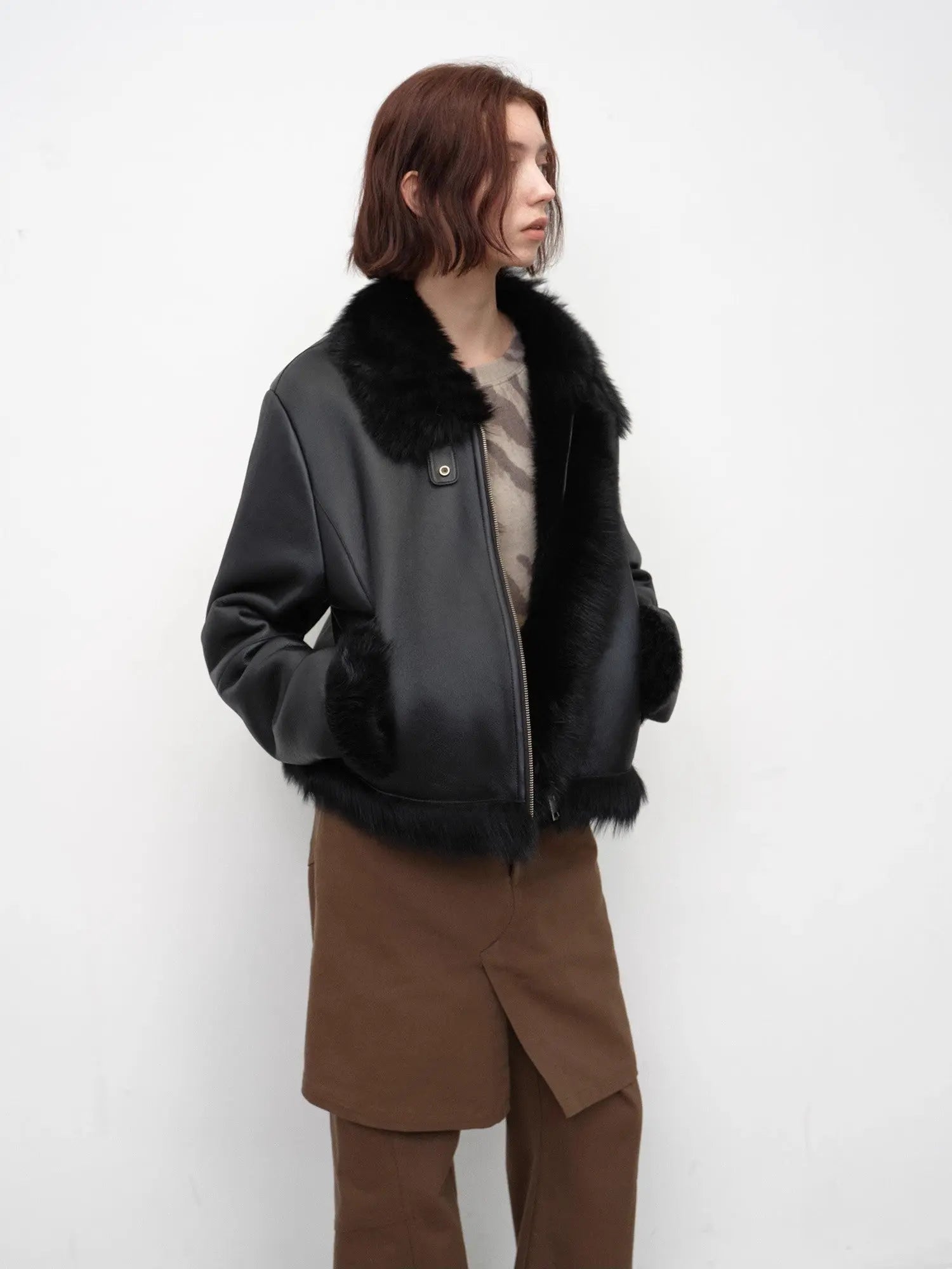 Woman wearing the black Toscana shearling short jacket, side view