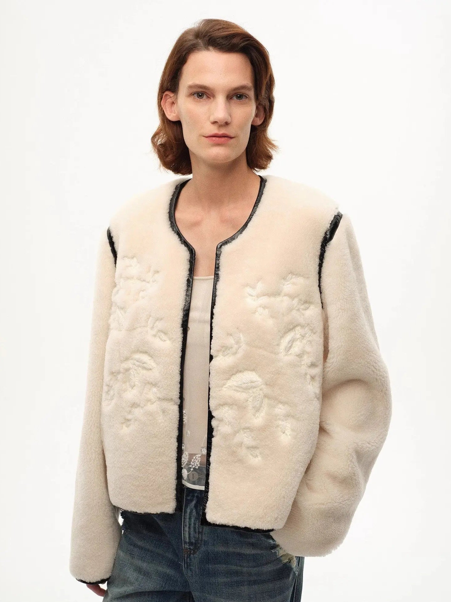 Model wearing the Muse Project embroidered Merino shearling coat, view 1