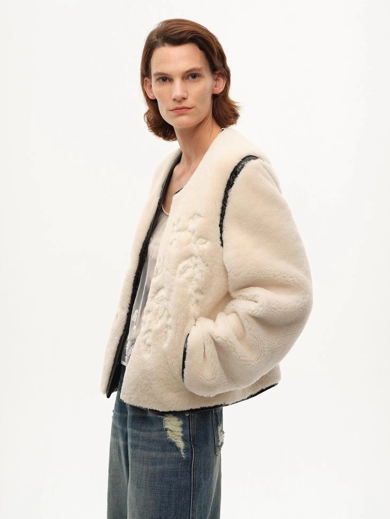 Model wearing the Muse Project embroidered Merino shearling coat, view 6