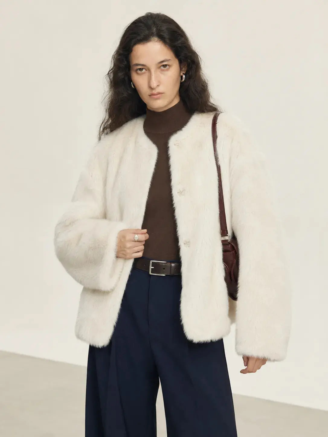 Woman wearing the Night in Paris off-white Toscana shearling coat, front view