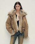 Model wearing Firelady Fur Nordic Woods Khaki cropped raccoon fur down parka front view