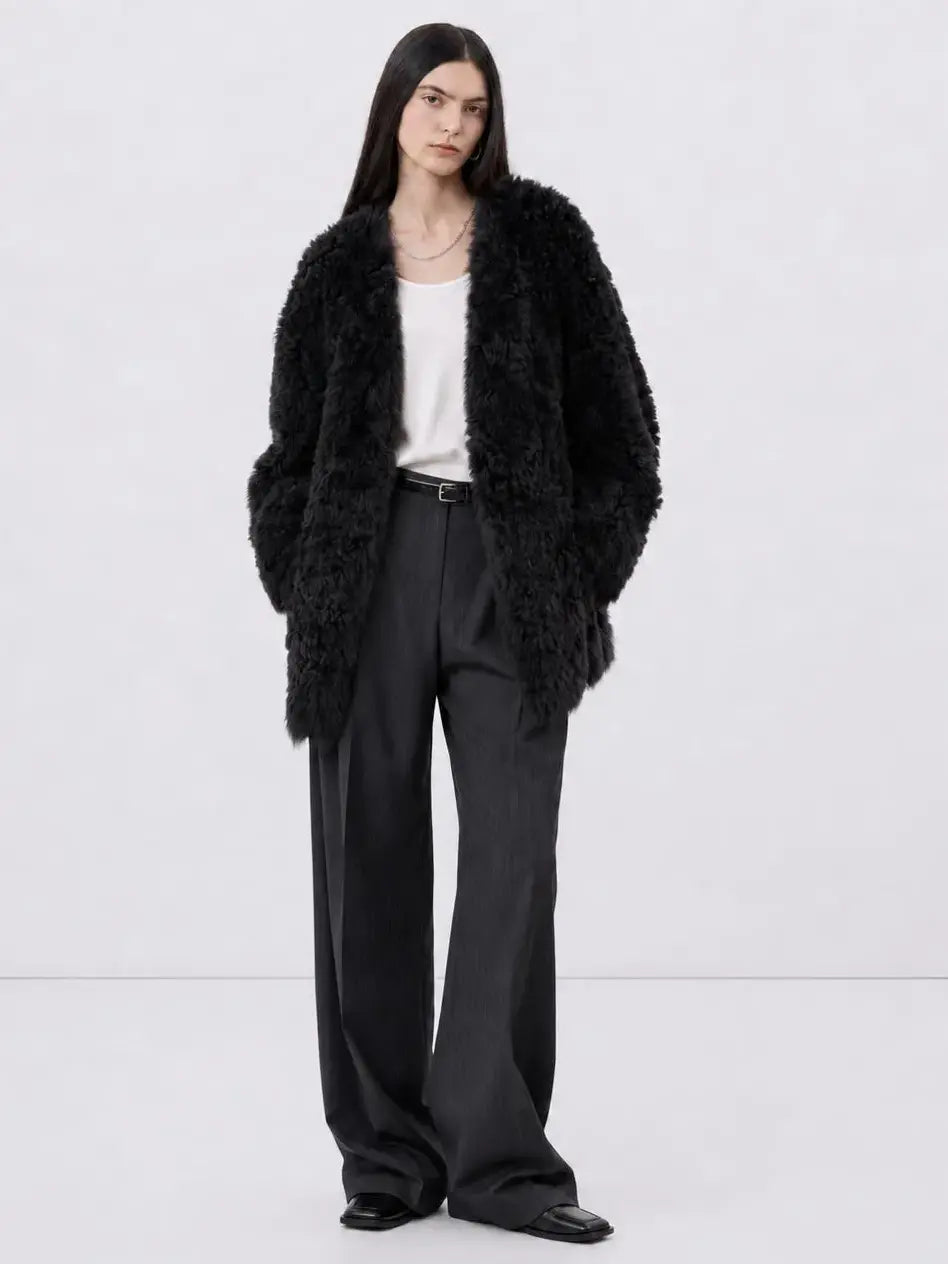 Model wearing the Peach Oolong classic black Toscana sheepskin winter coat, full-length view