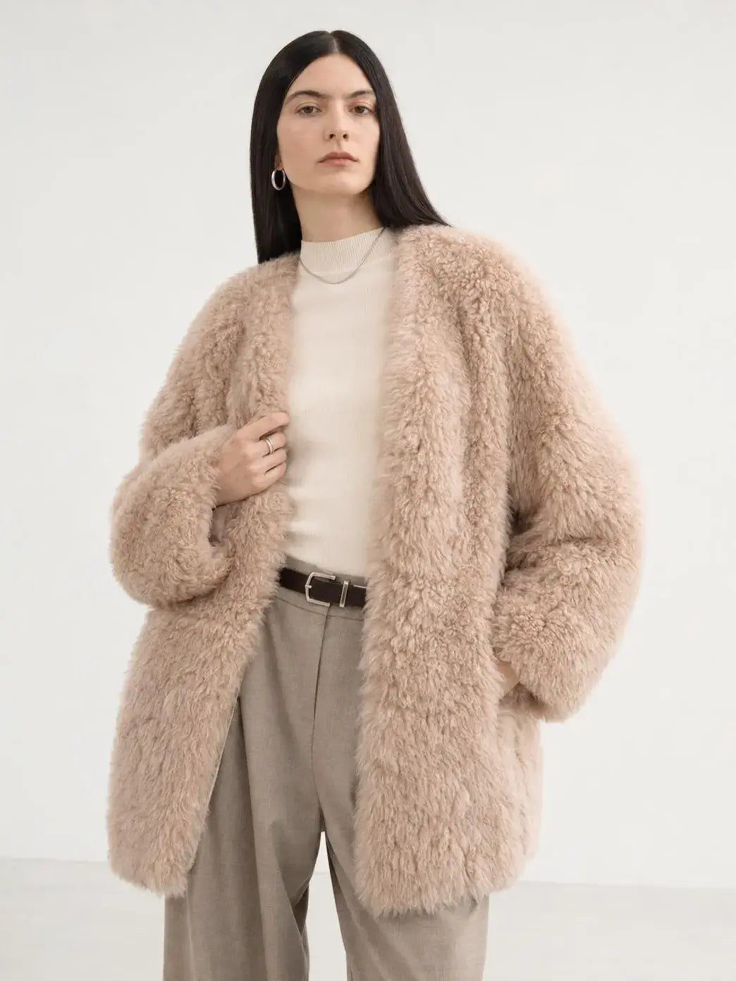 Model wearing the Peach Oolong misty pink Toscana sheepskin winter coat, close front view