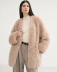Model wearing the Peach Oolong misty pink Toscana sheepskin winter coat, close front view