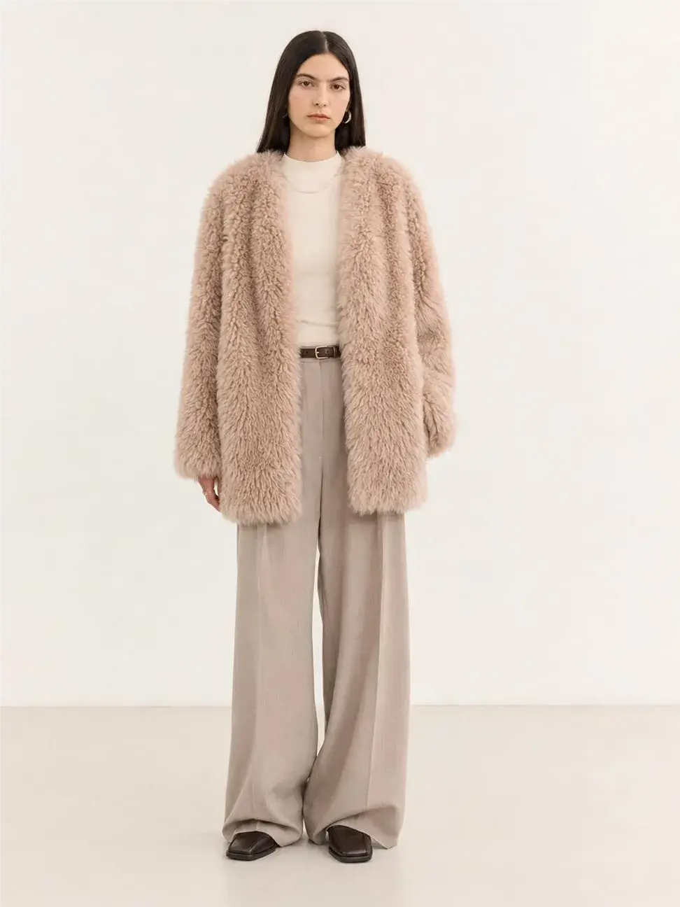 Model wearing the Peach Oolong misty pink Toscana sheepskin winter coat, full-length view