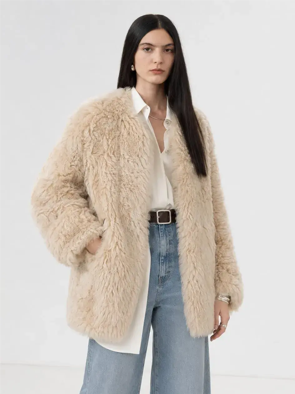 Model wearing the Peach Oolong morning mist white Toscana sheepskin winter coat, close front view