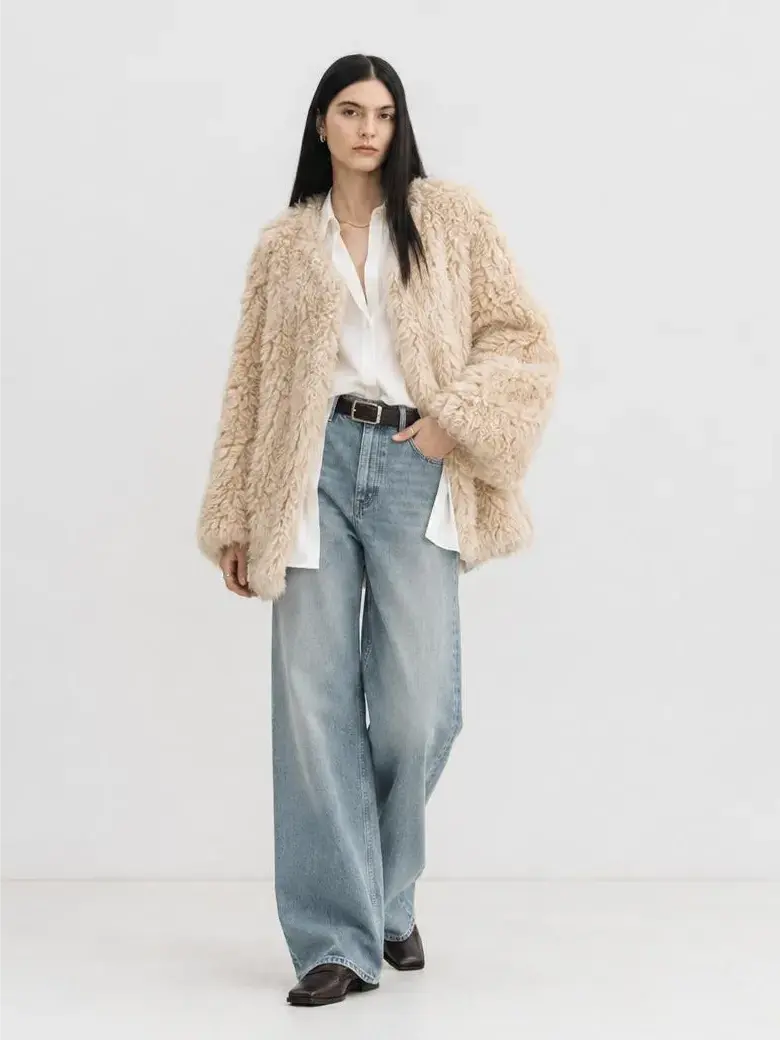 Model wearing the Peach Oolong morning mist white Toscana sheepskin winter coat, full-length view
