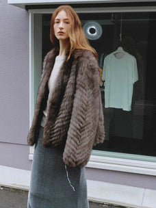 Polar Night Star Gray Brown fox fur coat in an outdoor setting, side view