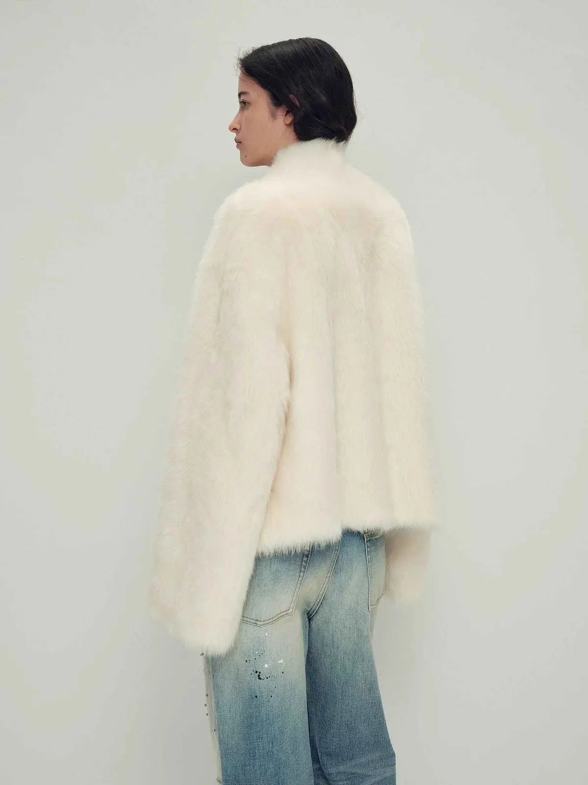 Model wearing the Practical Wearism cream white Toscana sheepskin coat, back view