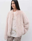 Model wearing the Practical Wearism dirty pink Toscana sheepskin coat, front view