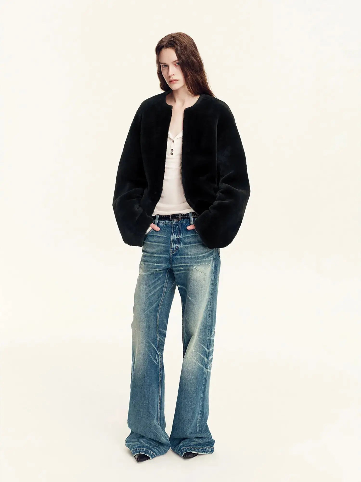Woman wearing the Quiet Warmth black Merino shearling jacket, full-length view