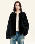 Quiet Warmth black Merino shearling jacket styled with denim