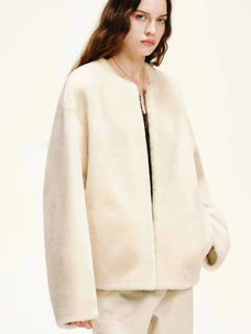 Woman styling the Quiet Warmth ivory Merino shearling jacket, three-quarter view