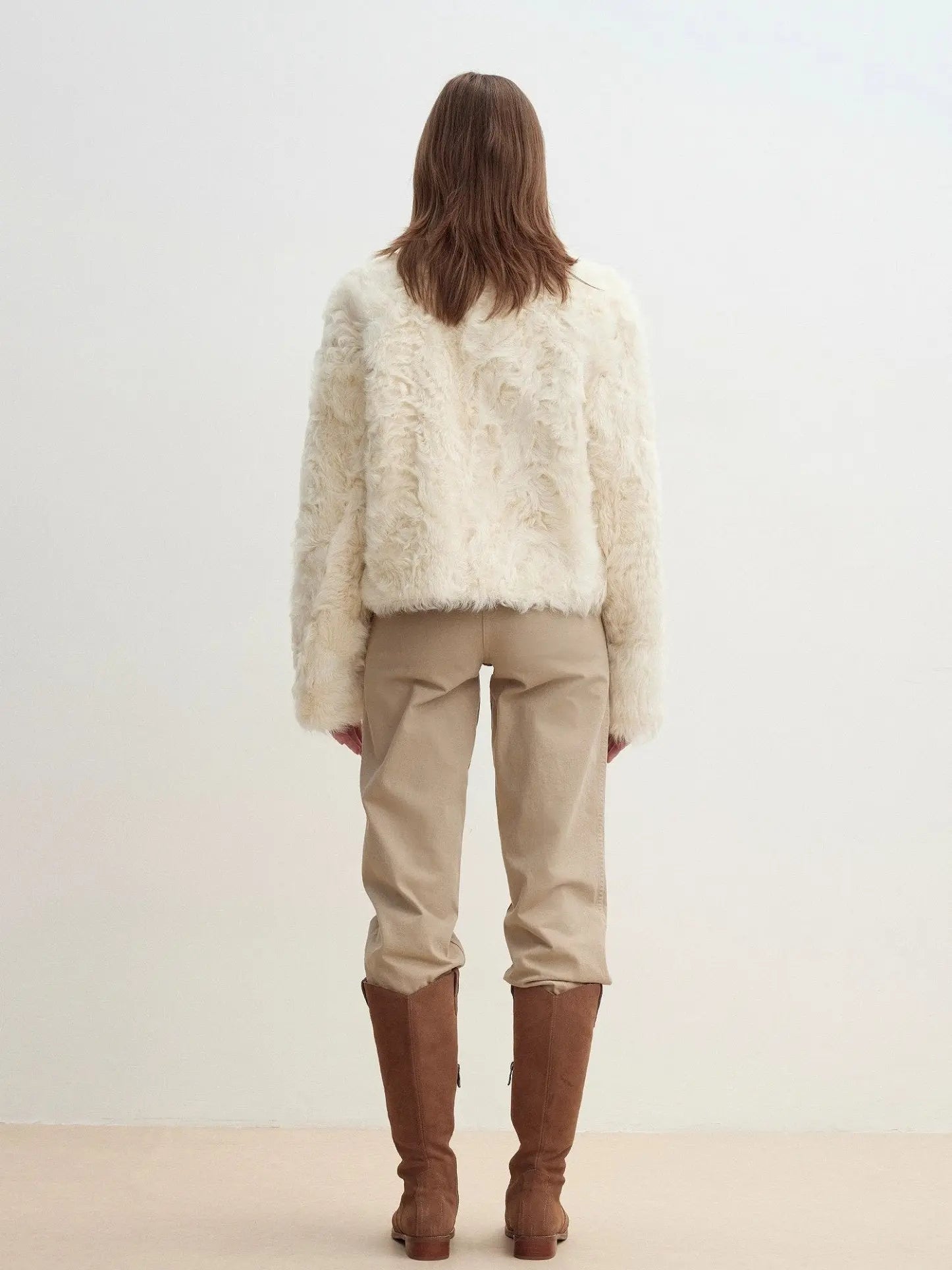 Model wearing the Rachel off-white two-tone curly wool shearling coat, back view