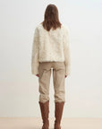 Model wearing the Rachel off-white two-tone curly wool shearling coat, back view