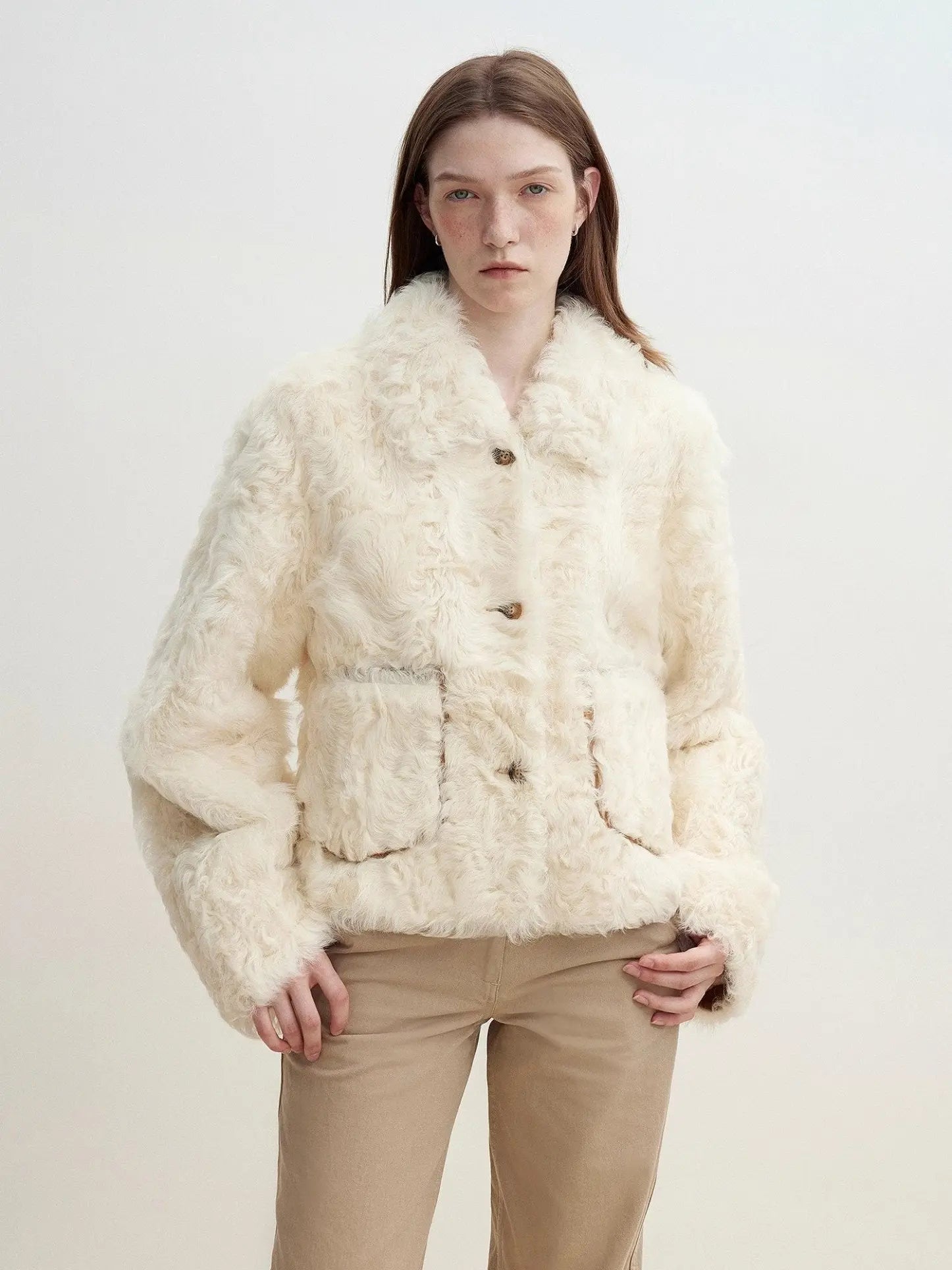 Model wearing the Rachel off-white two-tone curly wool shearling coat, close front view
