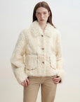 Model wearing the Rachel off-white two-tone curly wool shearling coat, close front view